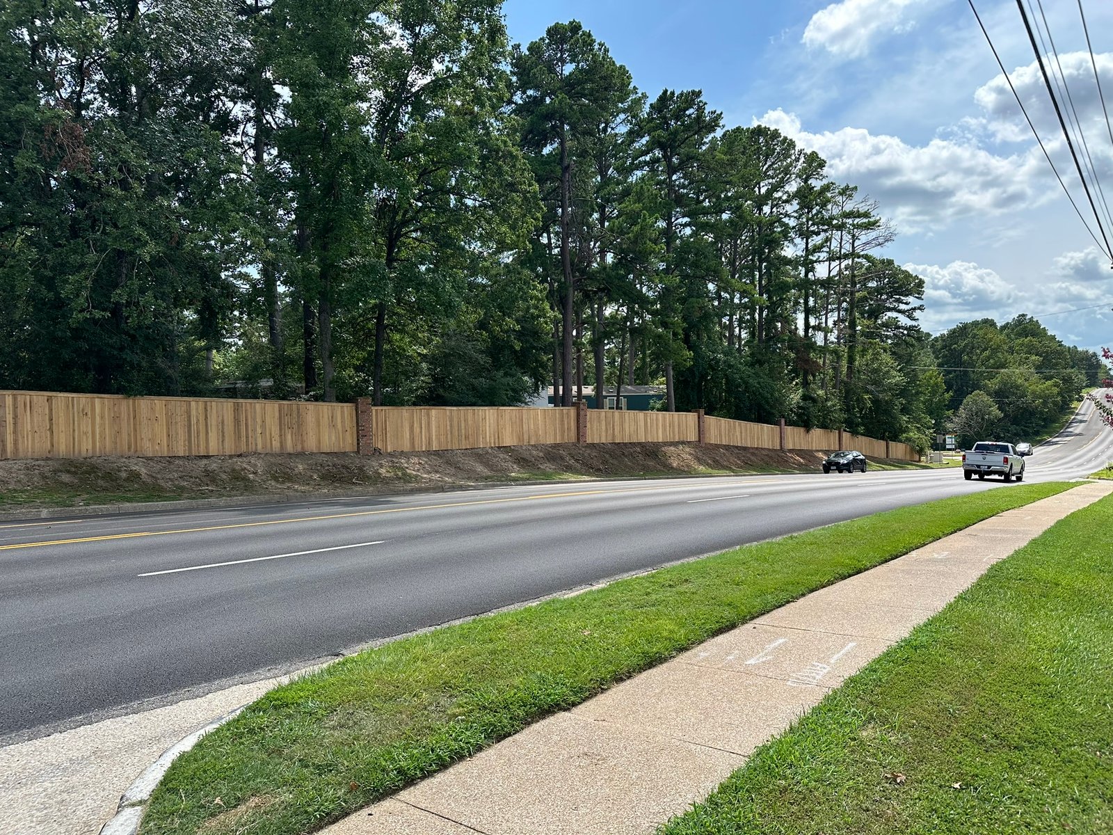 Wood privacy fence installed along a North Texas roadside by Bluebonnet Home Resolutions