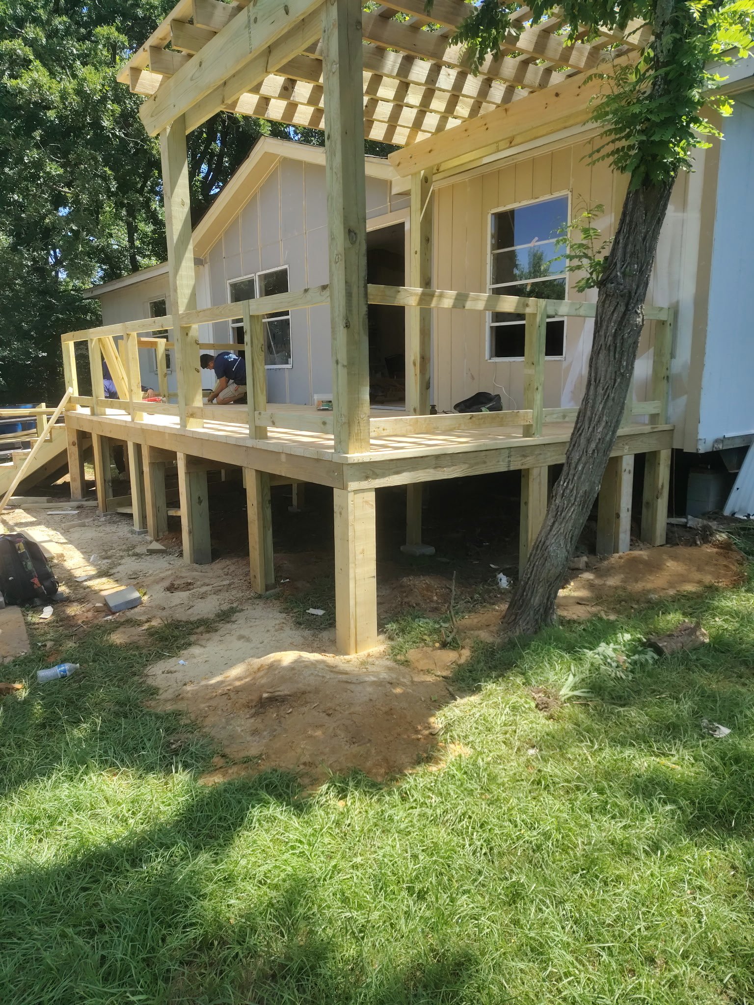 New deck and pergola under construction during a full exterior remodel