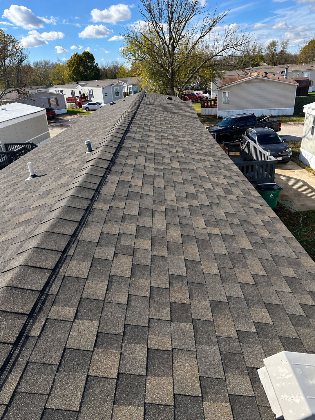 Aerial view of a finished shingle roof installed by Bluebonnet Home Resolutions